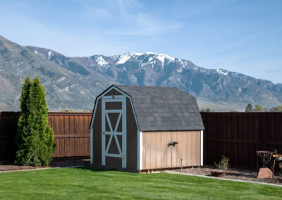 Barn style storage shed with mountains in the background