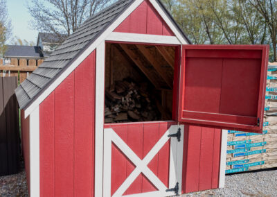Red shed with white trim and a steep incline roof