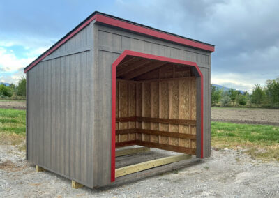 Gray and red lean-to shed with an open front