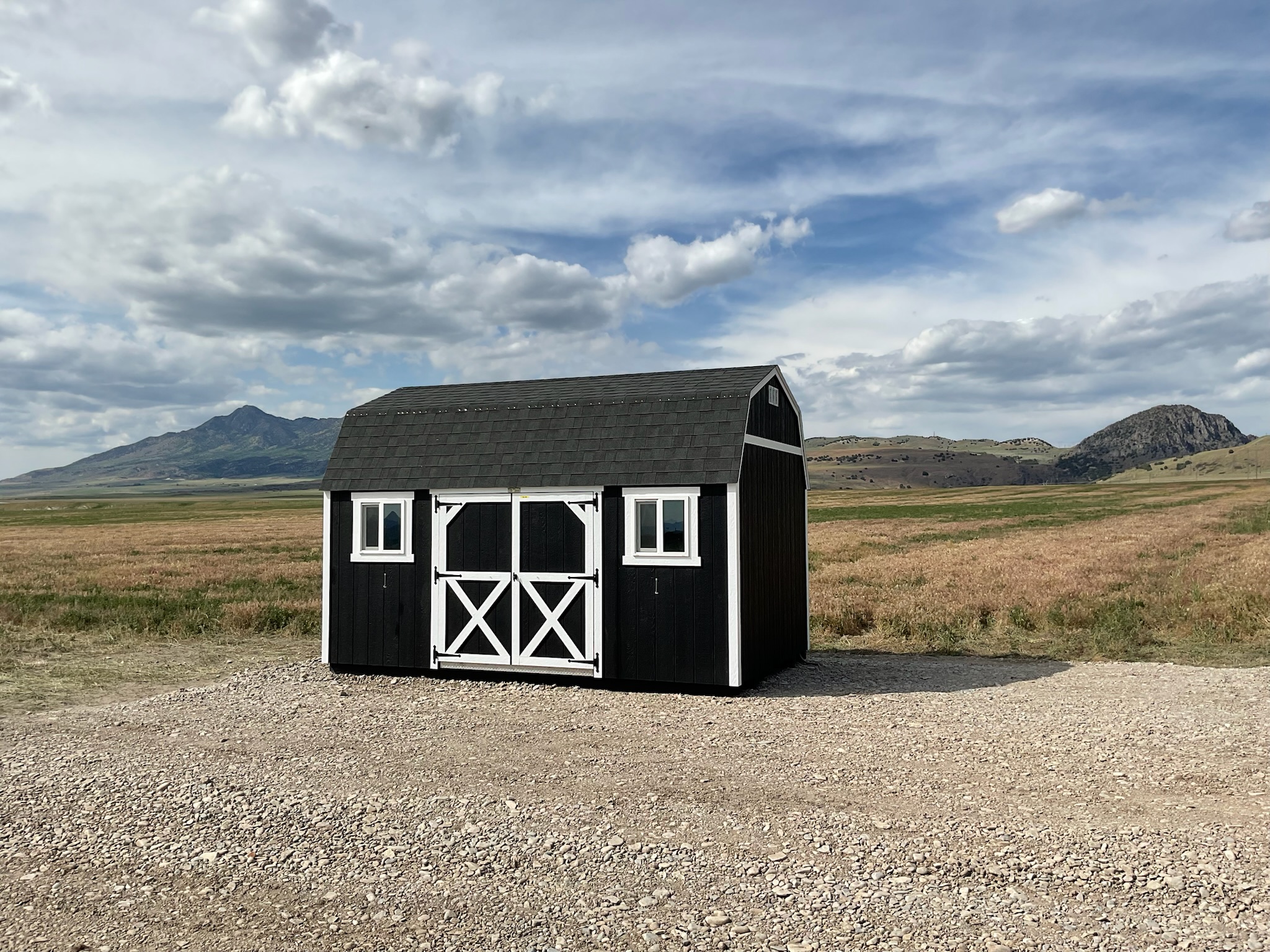 Black Barn style shed in front of mountains