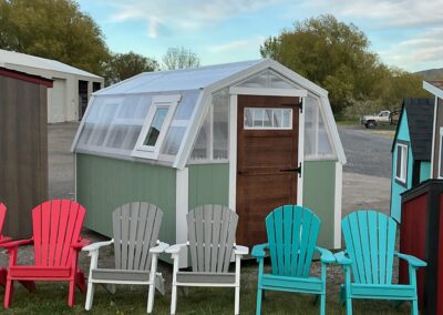 Custom greenhouse with Adirondacks in front